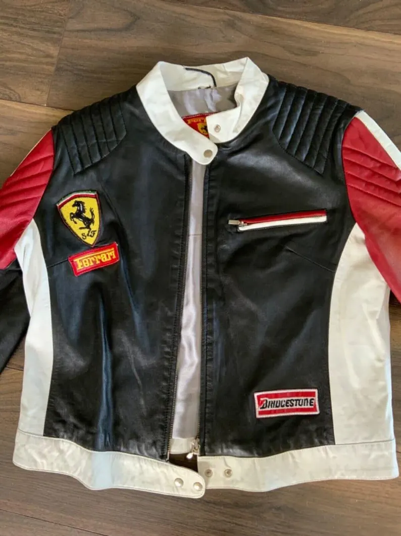 Detailed shot of the chest area, highlighting the Ferrari shield and the Bridgestone sponsor patch on the leather jacket.
