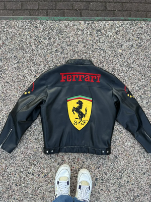 Close-up of the jacket's chest area, highlighting "Michael Schumacher F1 World Champion" text and the red "Ferrari" stripe.