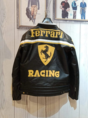 Back view of the black leather Ferrari jacket showing the large yellow Ferrari text, Scuderia logo, and RACING text below.