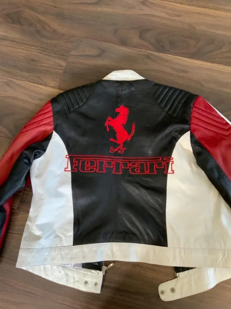 Black, white, and red Ferrari jacket on a wooden surface