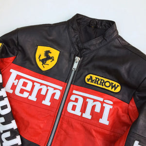 Black, red, and yellow racing jacket with Ferrari and Arrow logos on a white background