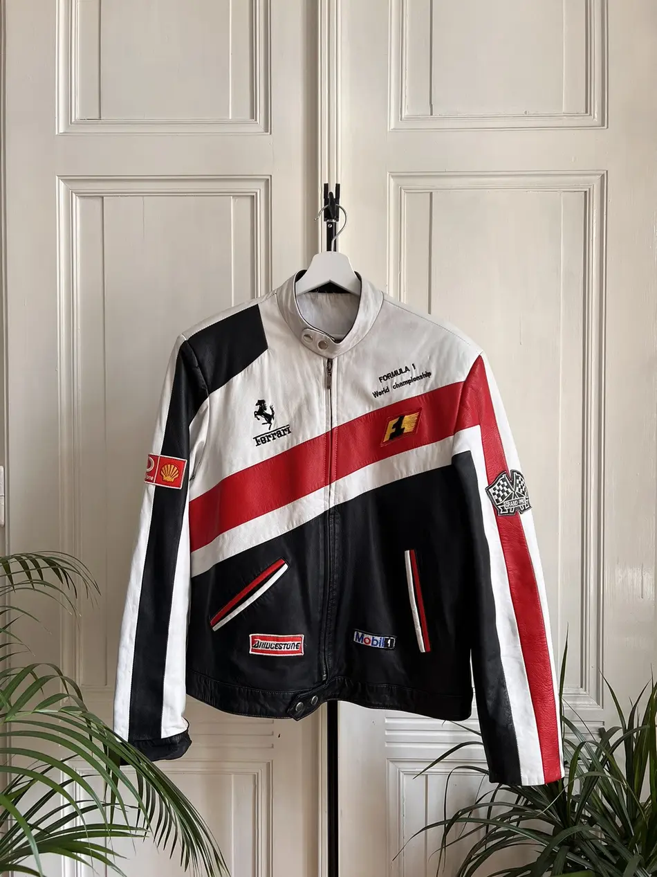 Front view of a white, black, and red leather Ferrari Formula 1 World Championship racing jacket with Bridgestone and Mobil 1 logos.