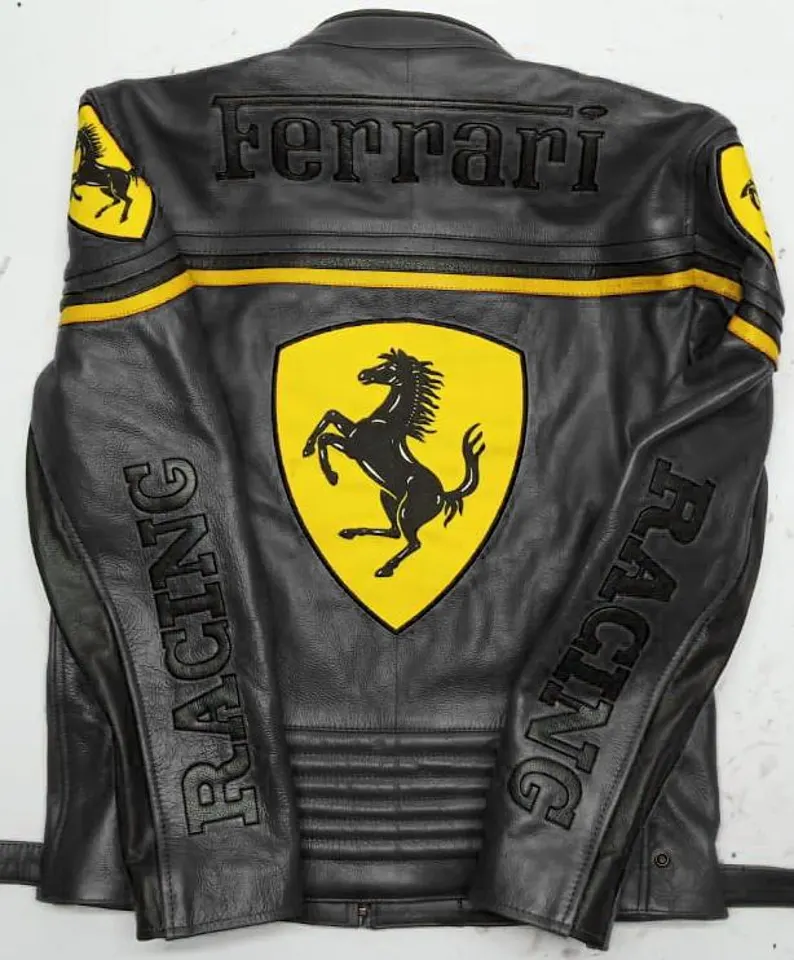 Detailed shot of the front of the black and yellow Ferrari Racing leather jacket showing the Bell and Chesterfield patches and the large embossed Ferrari lettering.

