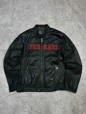 Full front view of a sleek black leather Ferrari jacket with red embroidered FERRARI text across the chest.