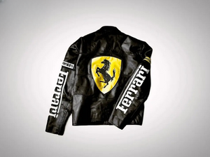 Detailed shot of the front of the black and White Ferrari Racing leather jacket showing the Vodafone and Michelin patches and the large embossed Ferrari lettering.