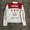Back view of the white and red racing jacket, highlighting large Ferrari, Shell, Marlboro, and Audi sponsor logos.